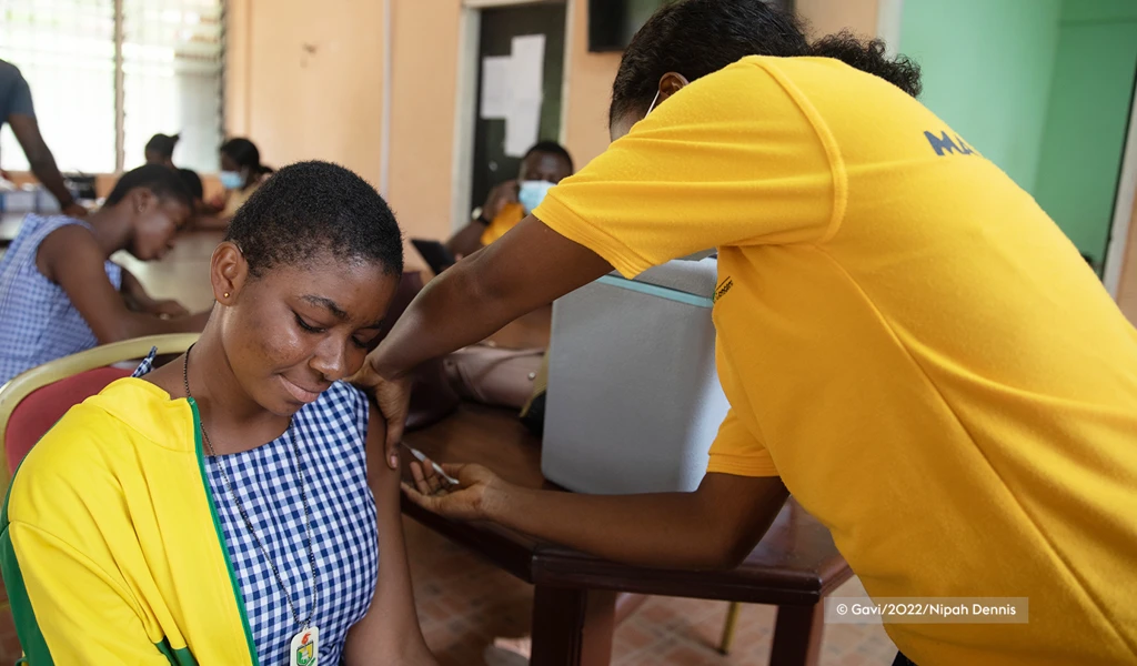 women sat down being given a COVID-19 vaccine